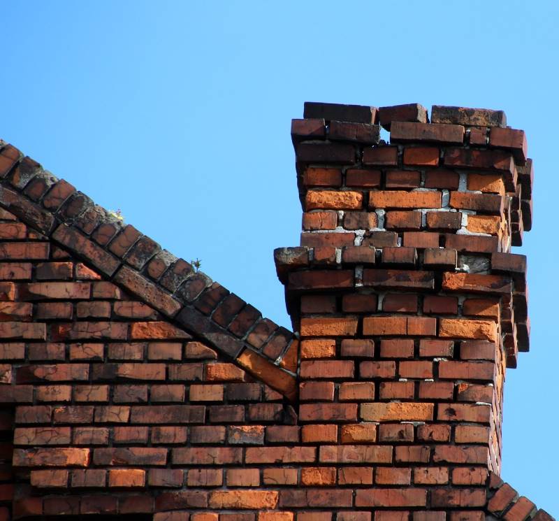 Damaged chimney on an Forest Hill home showing cracks and missing mortar